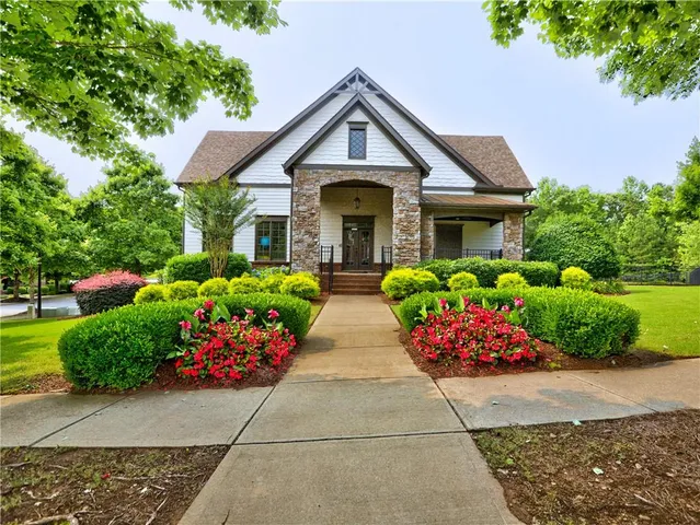 a front view of house with yard and flowers