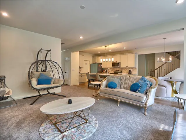 a living room with furniture a table and a chandelier