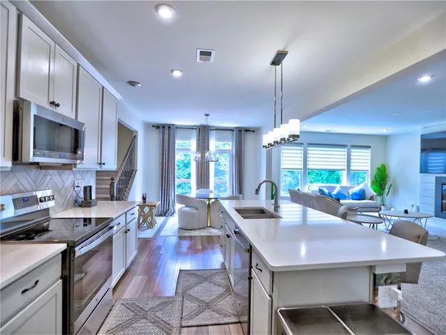 a kitchen with counter space dining table and chairs