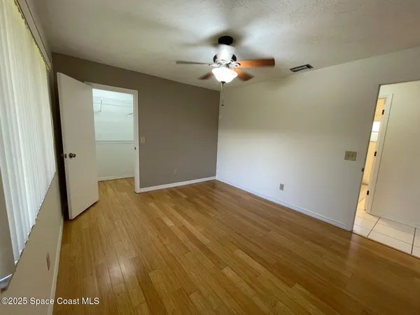 wooden floor in an empty room with a mirror