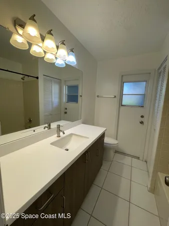a bathroom with a sink a large mirror and a shower