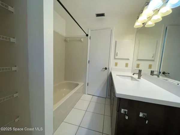 a bathroom with a sink a mirror and a bathtub