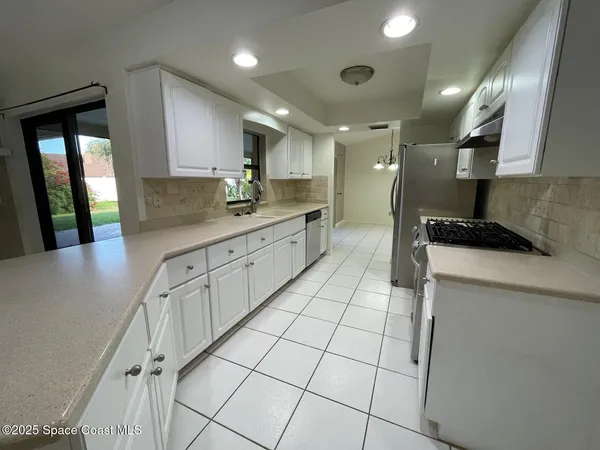 a kitchen with stainless steel appliances kitchen island granite countertop a sink and cabinets