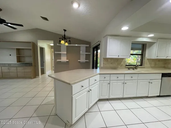 a kitchen with a sink and refrigerator