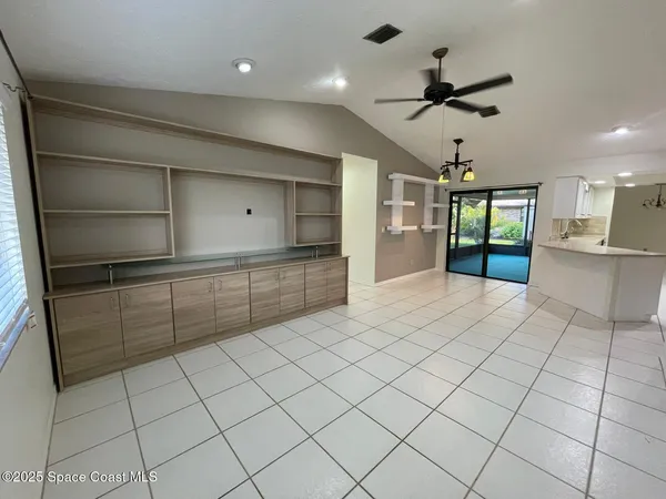 a kitchen with stainless steel appliances kitchen island granite countertop a refrigerator and a sink