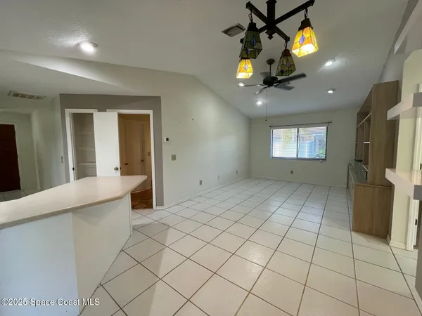 a view of an entryway and a chandelier fan