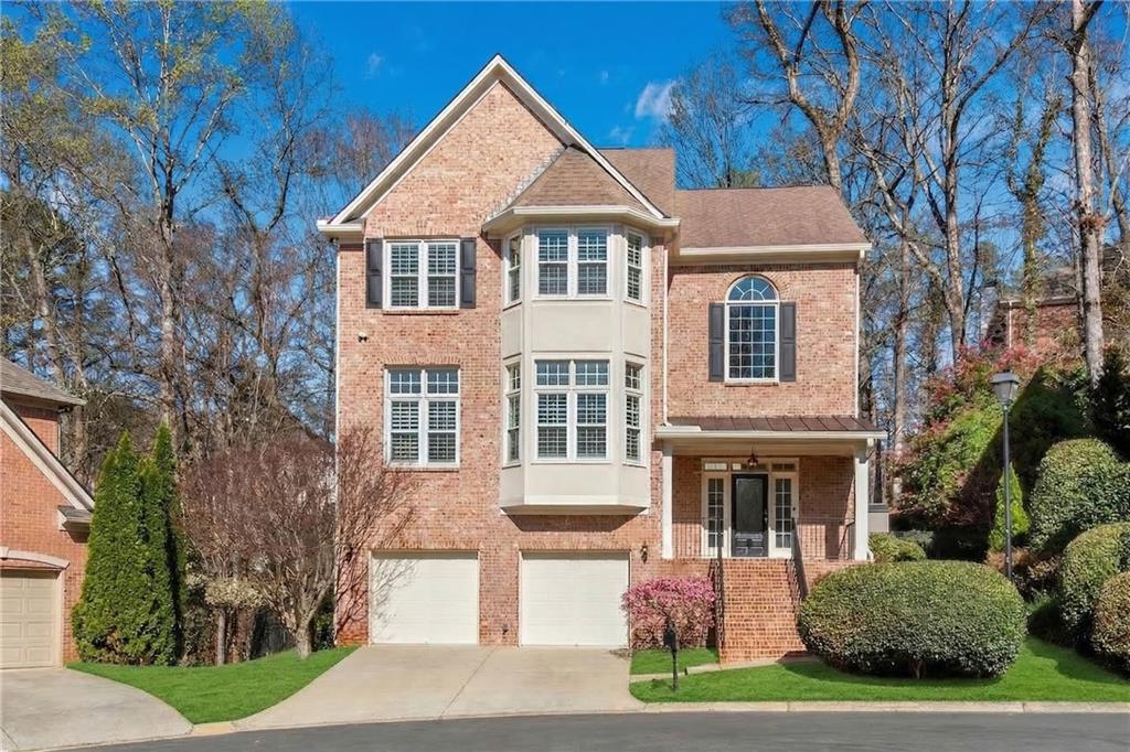 992 Wescott Lane Northeast Atlanta, GA 30342 - Photo 1 of 80 a front view of a house with yard and green space