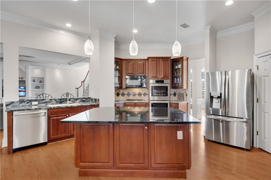 992 Wescott Lane Northeast Atlanta, GA 30342 - Photo 14 of 80 a kitchen with stainless steel appliances granite countertop a refrigerator and a stove