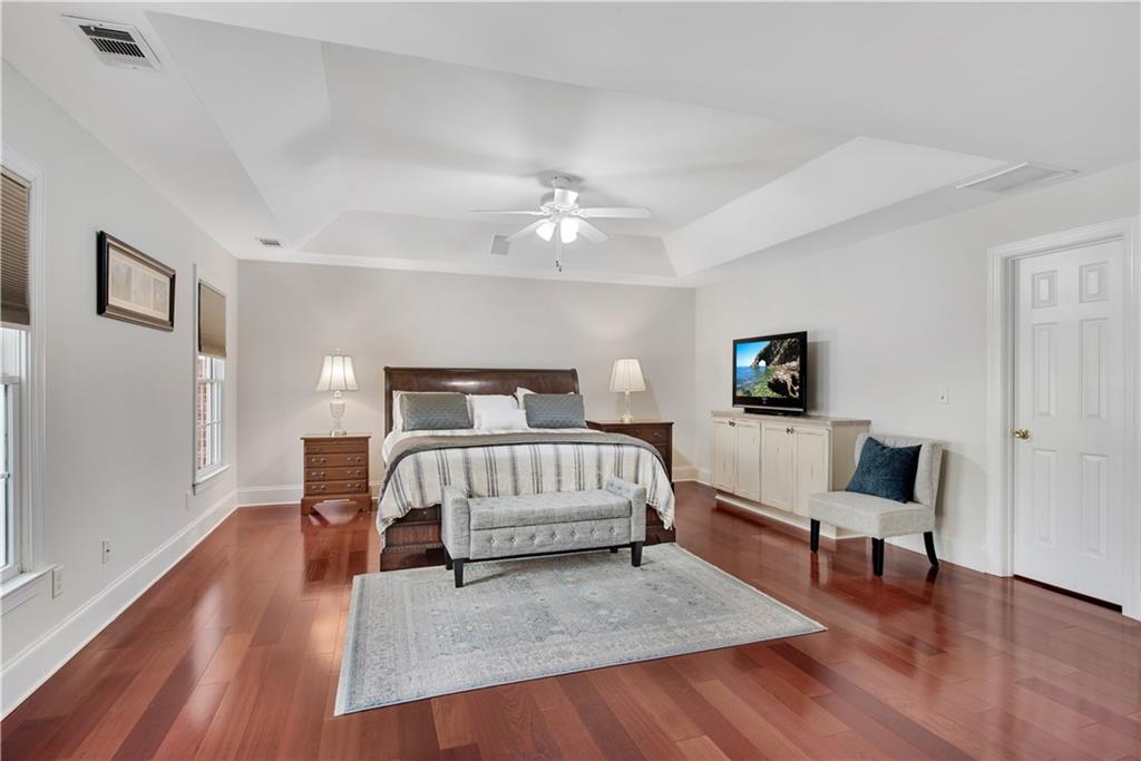 992 Wescott Lane Northeast Atlanta, GA 30342 - Photo 20 of 80 a spacious bedroom with a bed and a couch