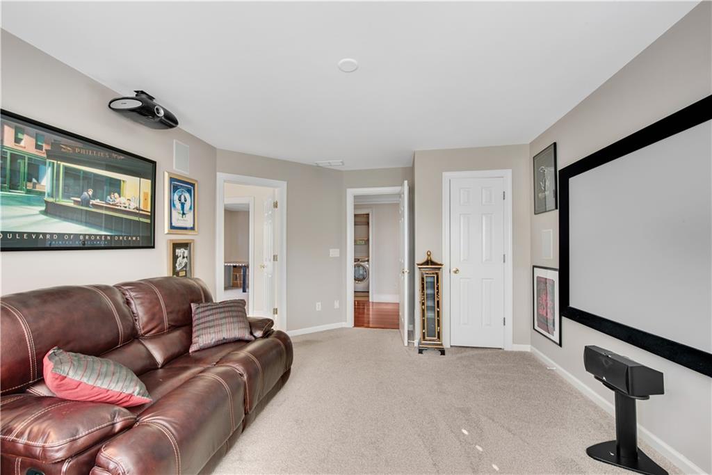 992 Wescott Lane Northeast Atlanta, GA 30342 - Photo 27 of 80 a living room with a couch and a flat screen tv
