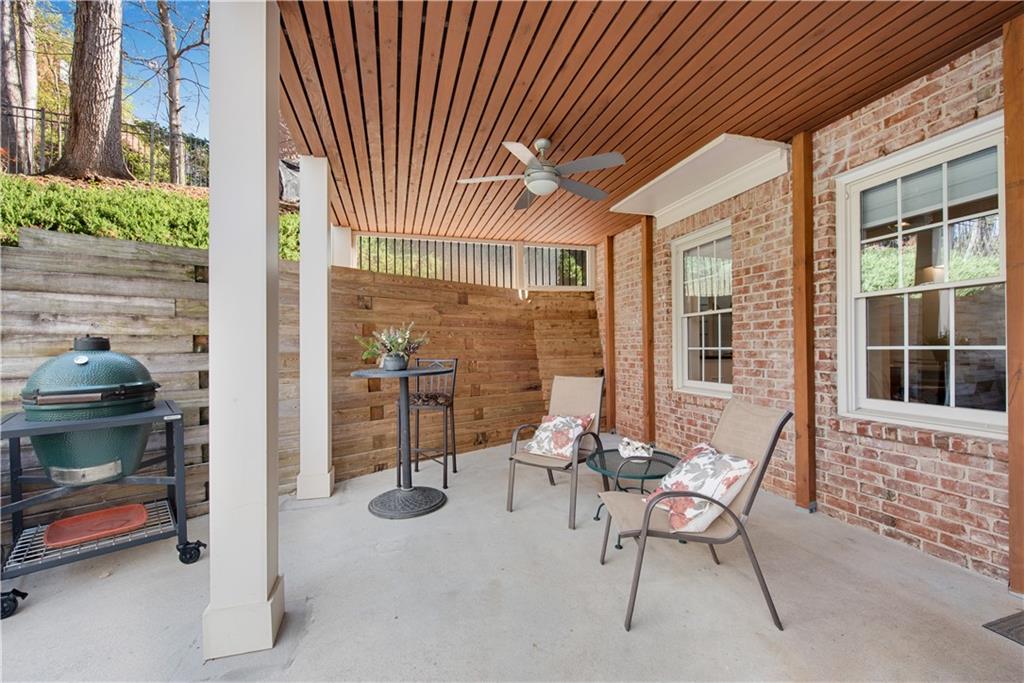 992 Wescott Lane Northeast Atlanta, GA 30342 - Photo 39 of 80 a view of a patio with table and chairs and potted plants
