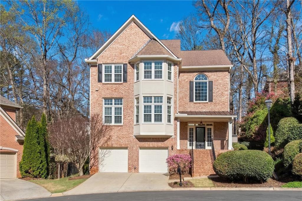 992 Wescott Lane Northeast Atlanta, GA 30342 - Photo 42 of 80 a front view of a house with garage