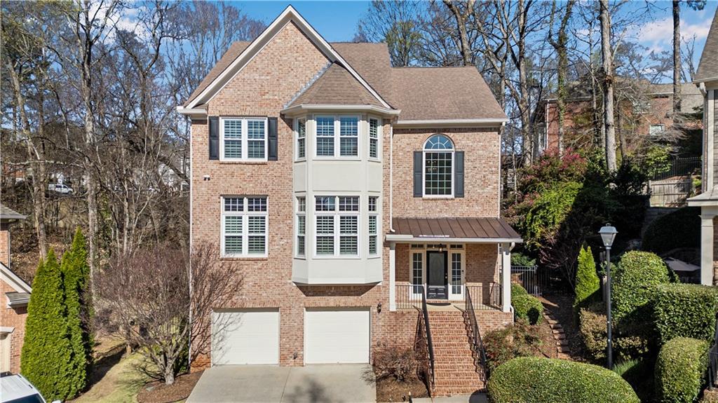 992 Wescott Lane Northeast Atlanta, GA 30342 - Photo 47 of 80 a front view of a house with a garden and plants