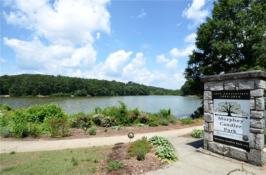 992 Wescott Lane Northeast Atlanta, GA 30342 - Photo 72 of 80 a view of a lake with a bench in front of house