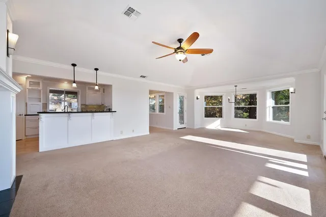 a kitchen with granite countertop white cabinets and stainless steel appliances