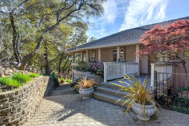 a front view of house with yard and trees