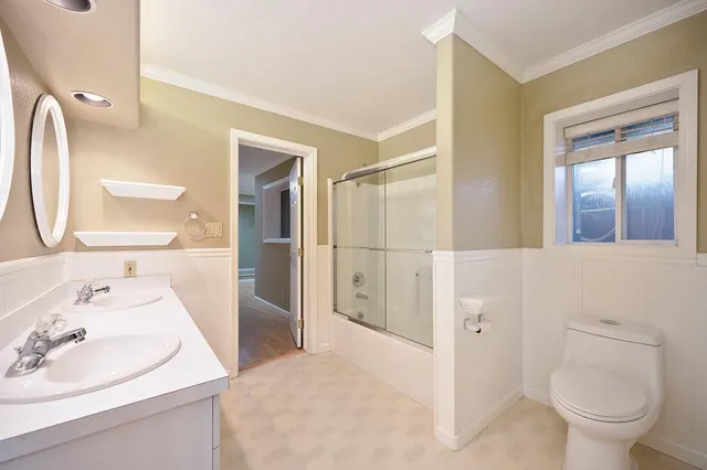 a view of a house with a large window and wooden fence