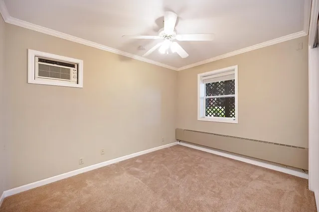 a view of house with a small yard and wooden fence