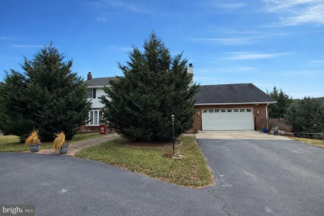 a view of a house with a yard and garage