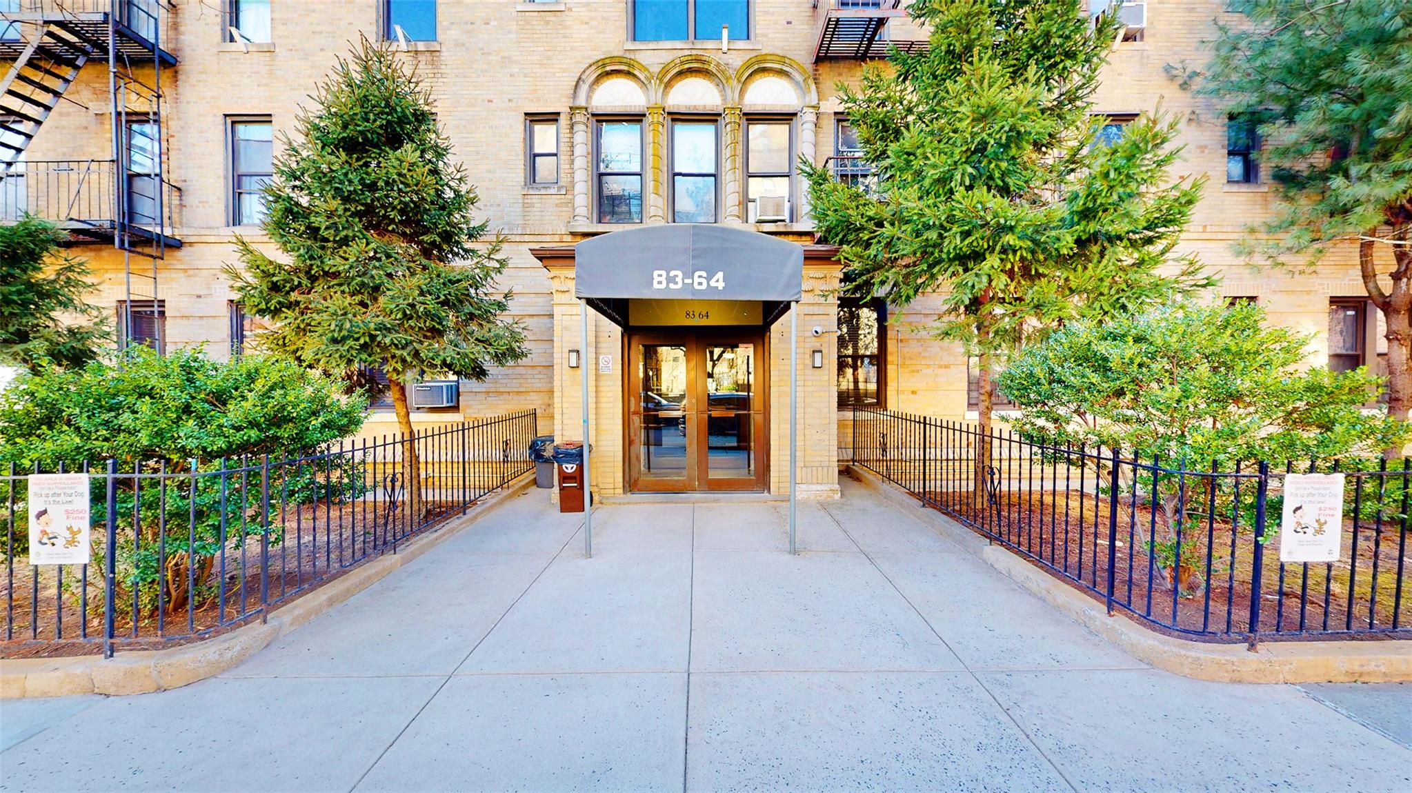 Entrance to property with brick siding and fence