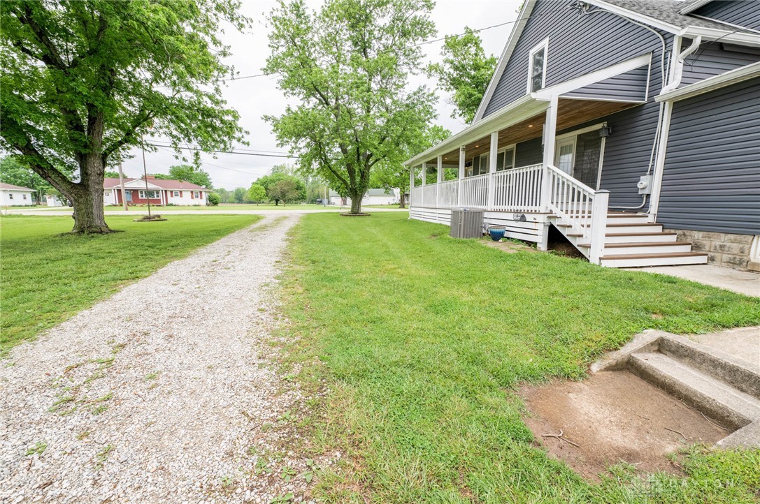 190 Swailes Road Troy, OH 45373 - Photo 62 of 82 This charming home features a welcoming porch, lush green lawn, and convenient gravel driveway.