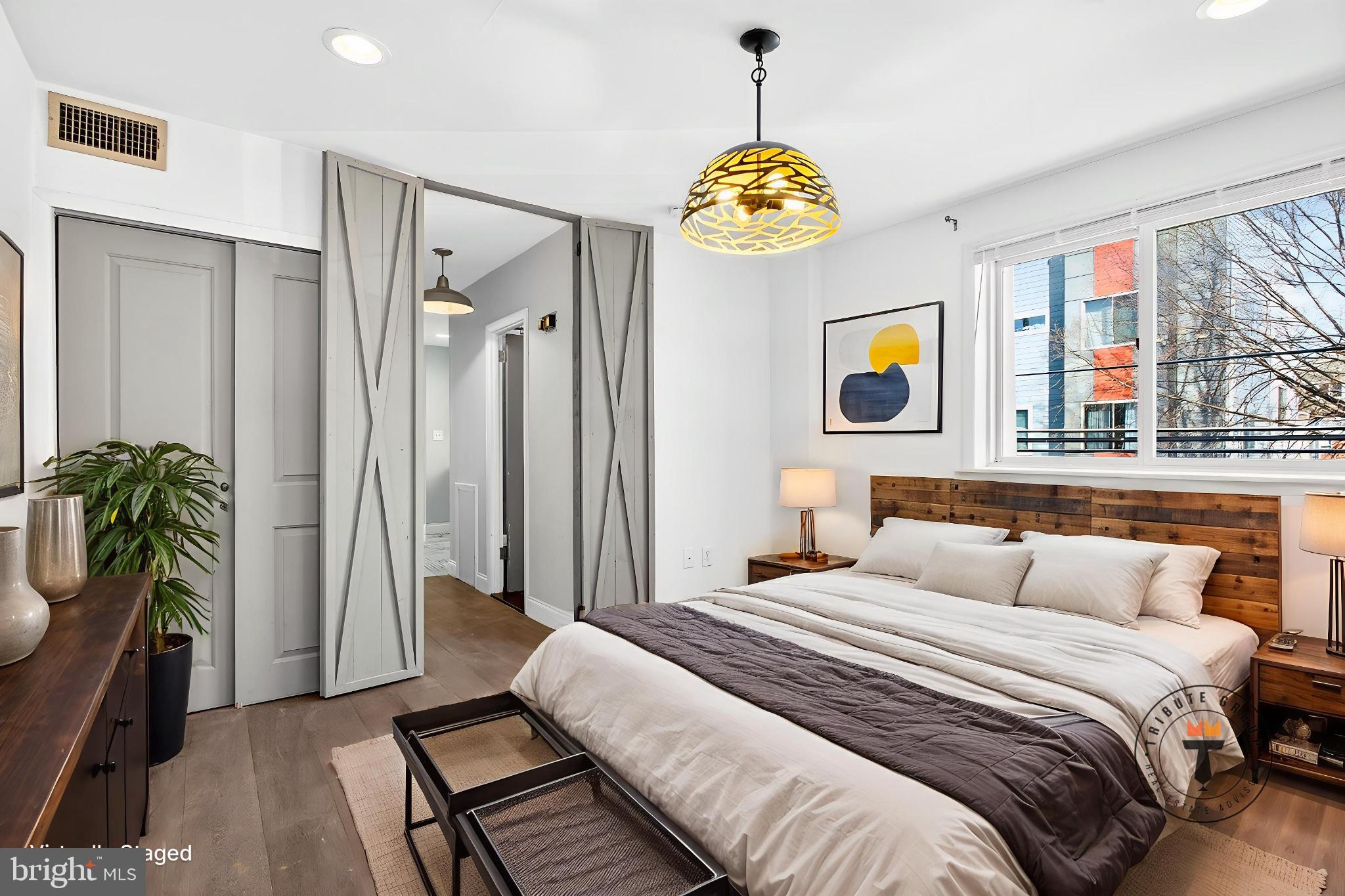 2579 Memphis Street, Unit 2 Philadelphia, PA 19125 - Photo 16 of 19 a bedroom with a bed and a chandelier