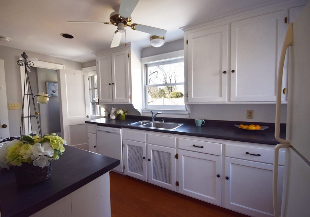 9 Wilde Road Wellesley, MA 02481 - Photo 6 of 18 a kitchen with granite countertop white cabinets white appliances and a window