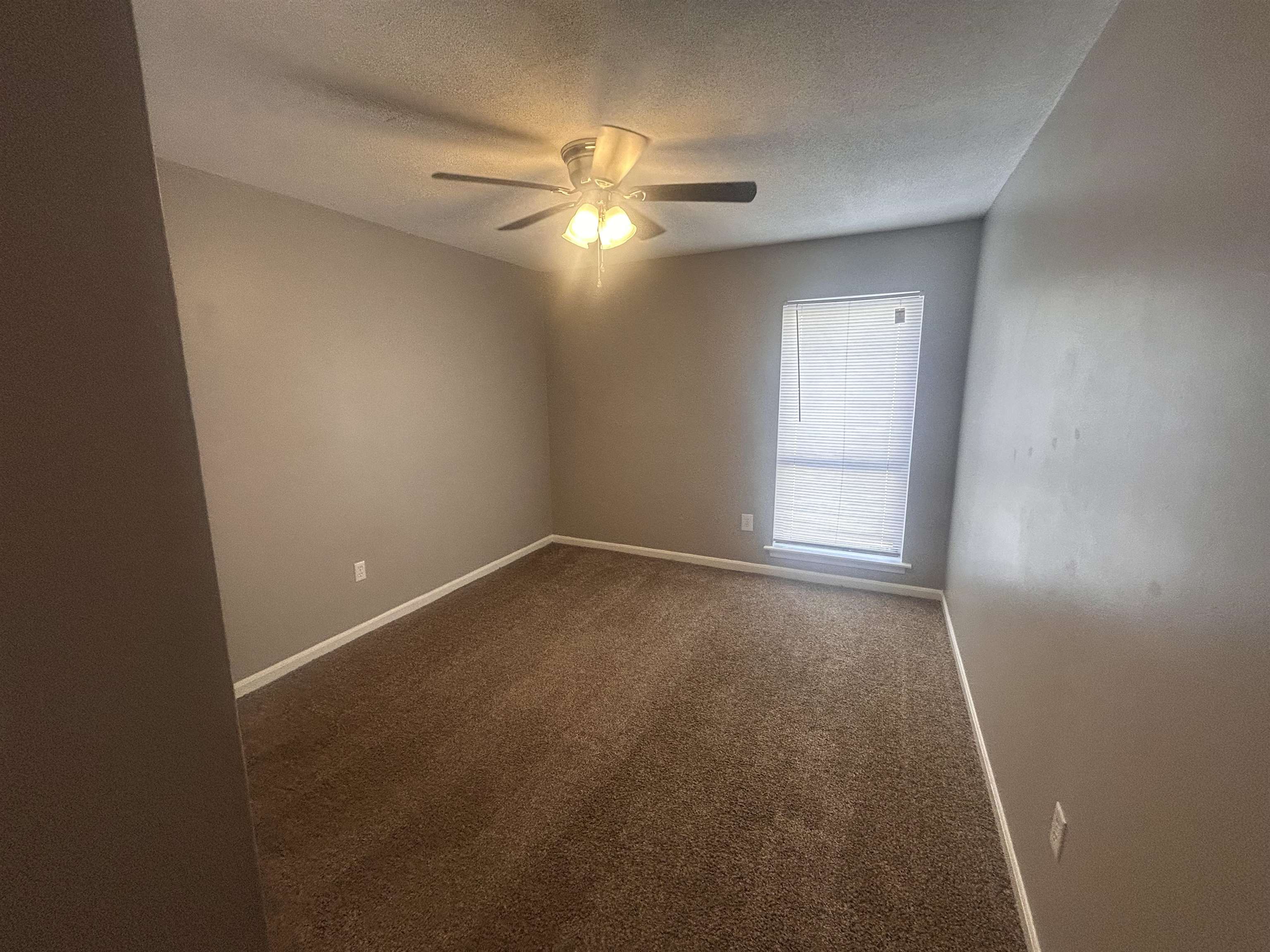 1772 6th Crompton Square, Unit B Memphis, TN 38134 - Photo 11 of 13 an empty room with windows and fan