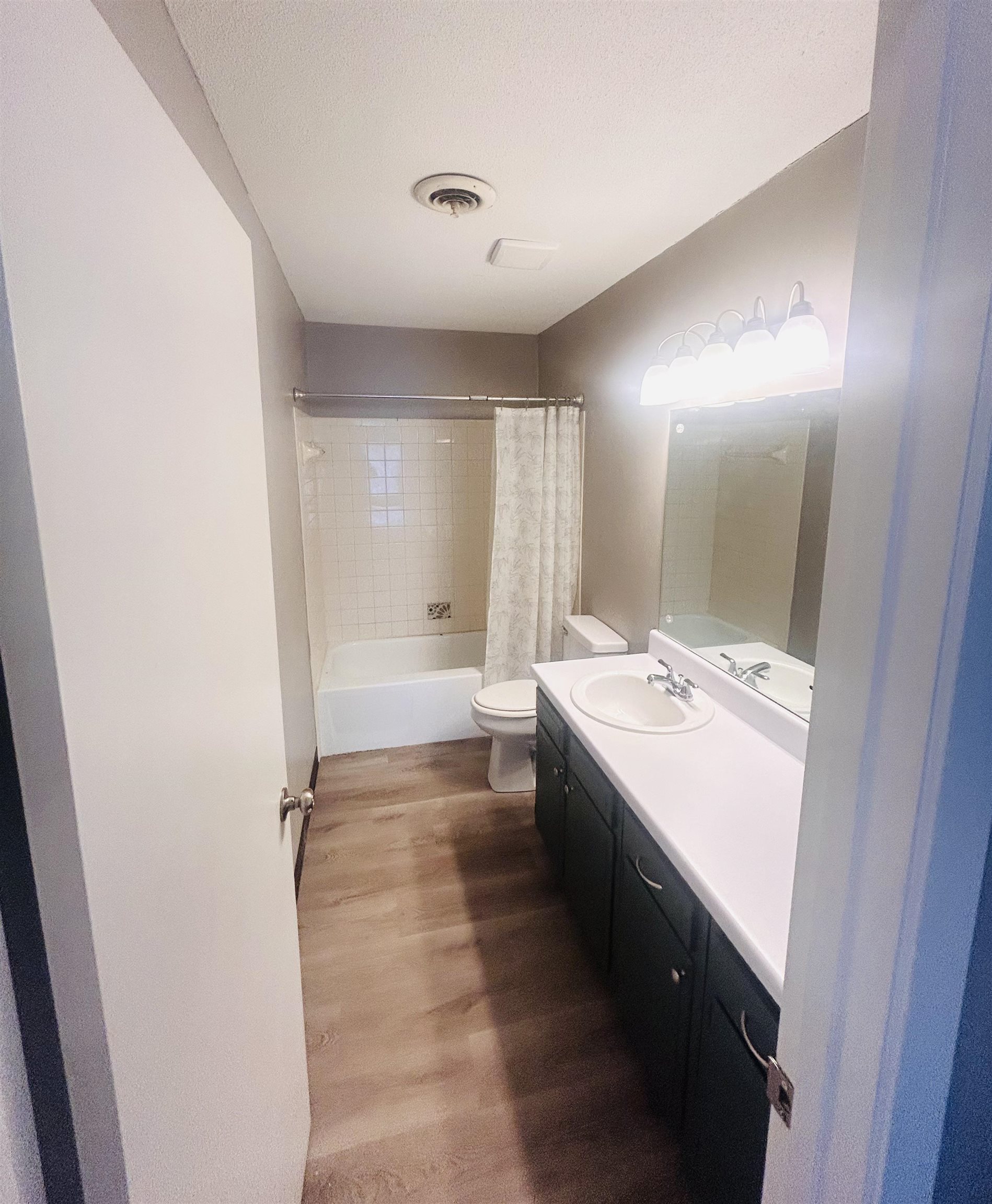 1772 6th Crompton Square, Unit B Memphis, TN 38134 - Photo 12 of 13 a bathroom with a double vanity sink toilet mirror and bathtub
