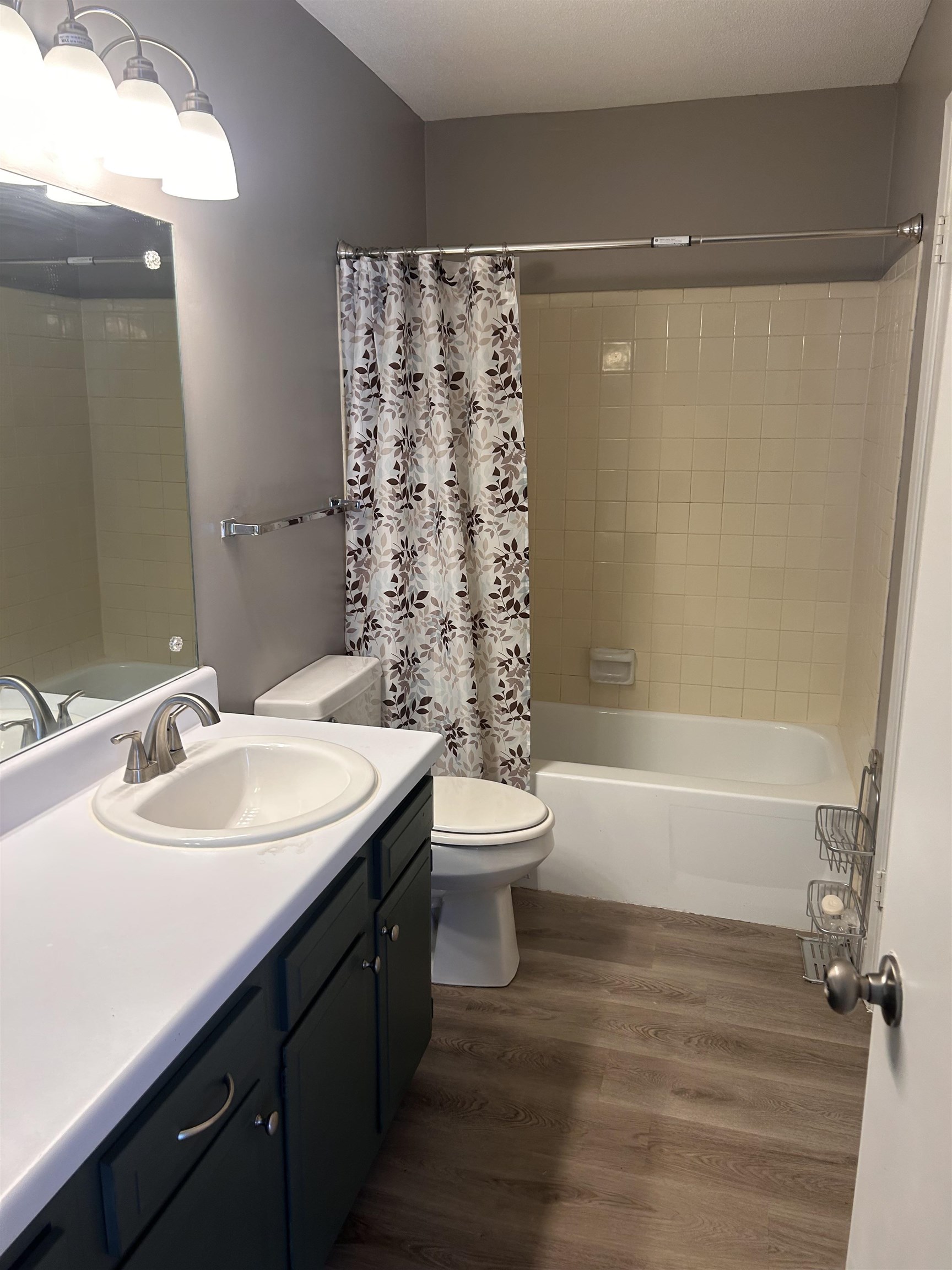 1772 6th Crompton Square, Unit B Memphis, TN 38134 - Photo 5 of 8 Full bath with vanity, shower / tub combo, and dark wood-type flooring