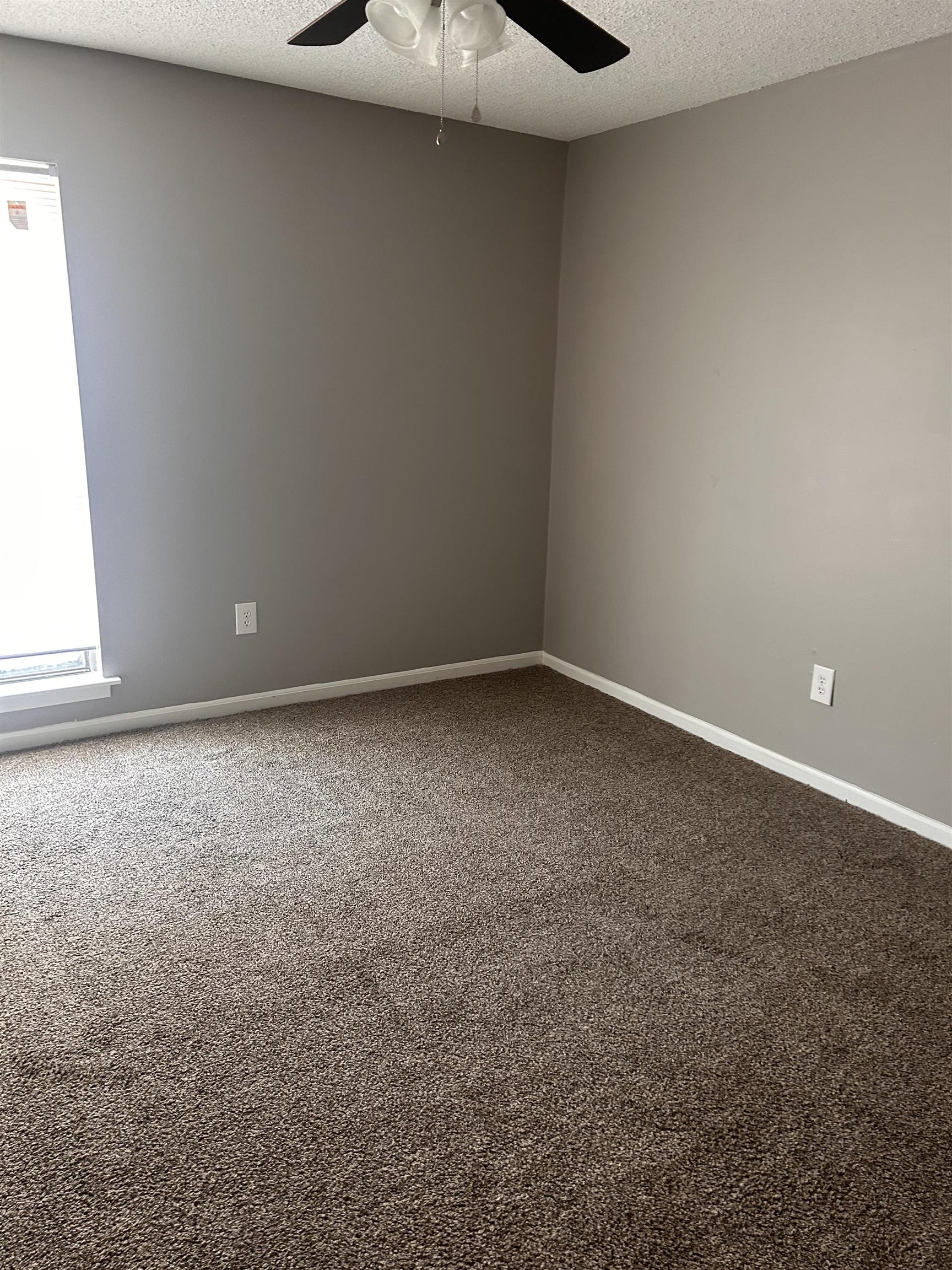 1772 6th Crompton Square, Unit B Memphis, TN 38134 - Photo 8 of 8 Empty room with carpet flooring, a textured ceiling, and ceiling fan