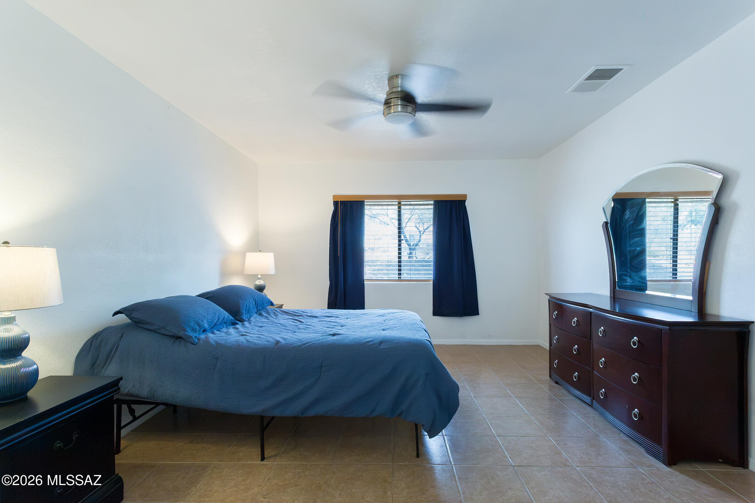 1081 Paseo Freno Rio Rico, AZ 85648 - Photo 23 of 46 a bedroom with a bed and a dresser in it