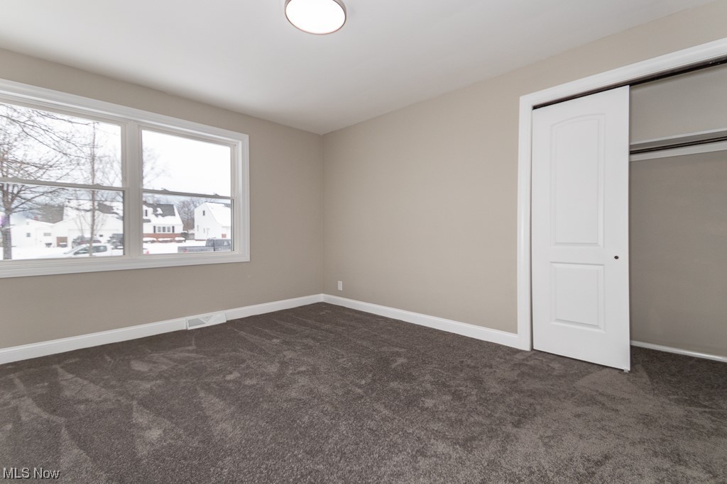 4980 Emmet Road Lyndhurst, OH 44124 - Photo 27 of 39 Unfurnished bedroom featuring a closet and dark colored carpet