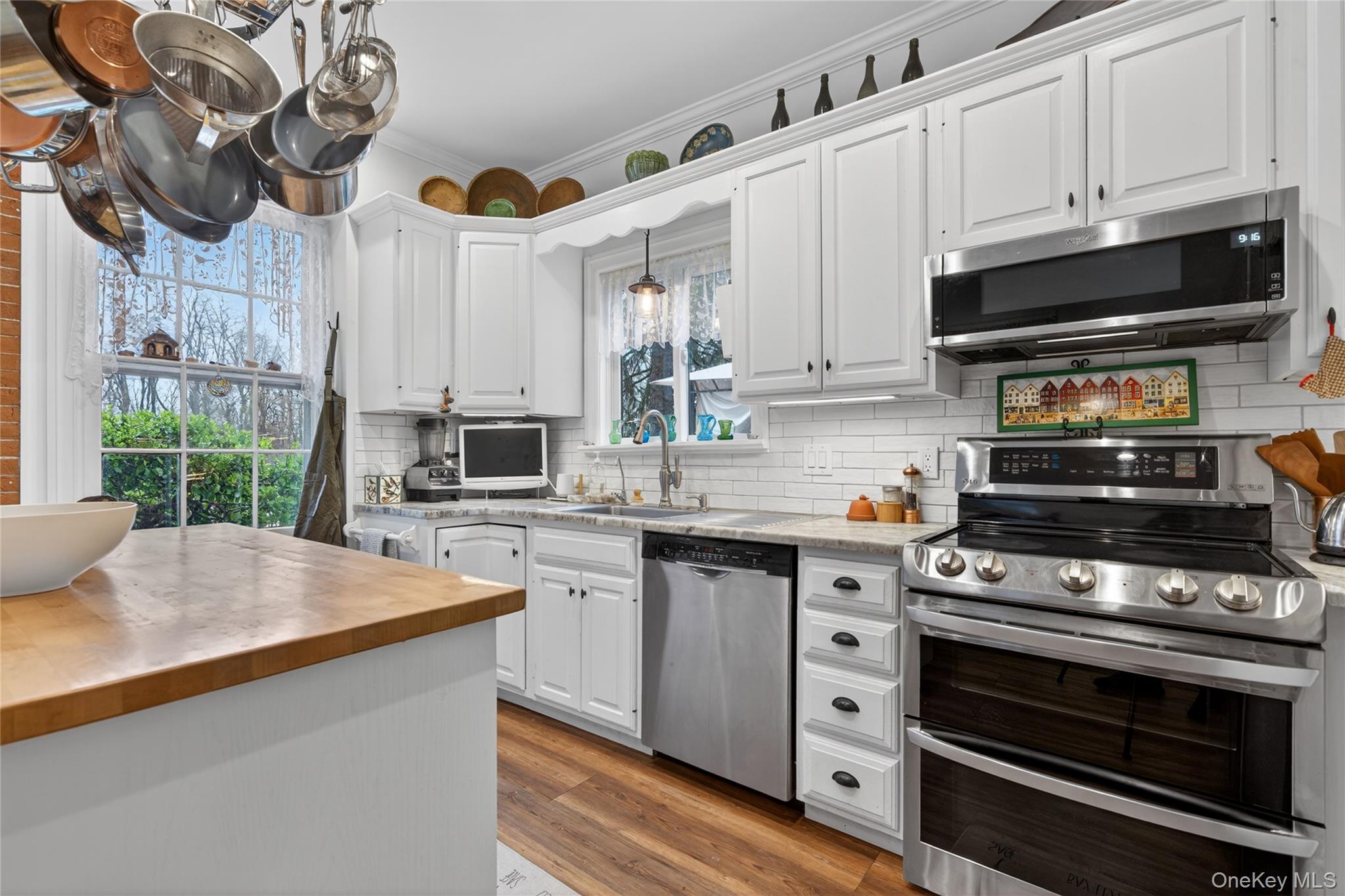 90 Quaker Avenue Cornwall, NY 12518 - Photo 16 of 50 a kitchen with stainless steel appliances a stove a microwave and cabinets
