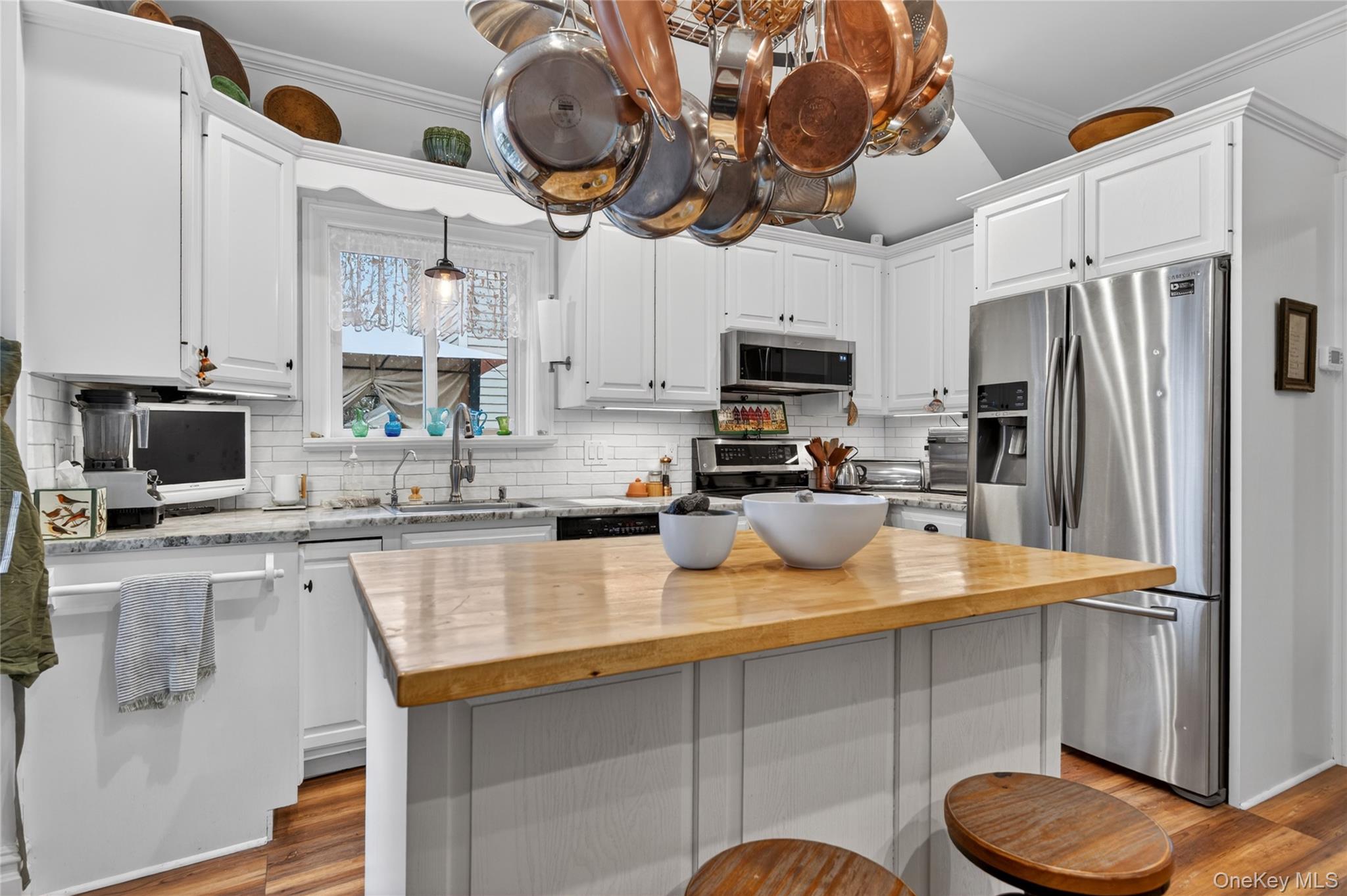 90 Quaker Avenue Cornwall, NY 12518 - Photo 18 of 50 a kitchen with stainless steel appliances granite countertop a sink a stove a microwave a refrigerator a stove and white cabinets