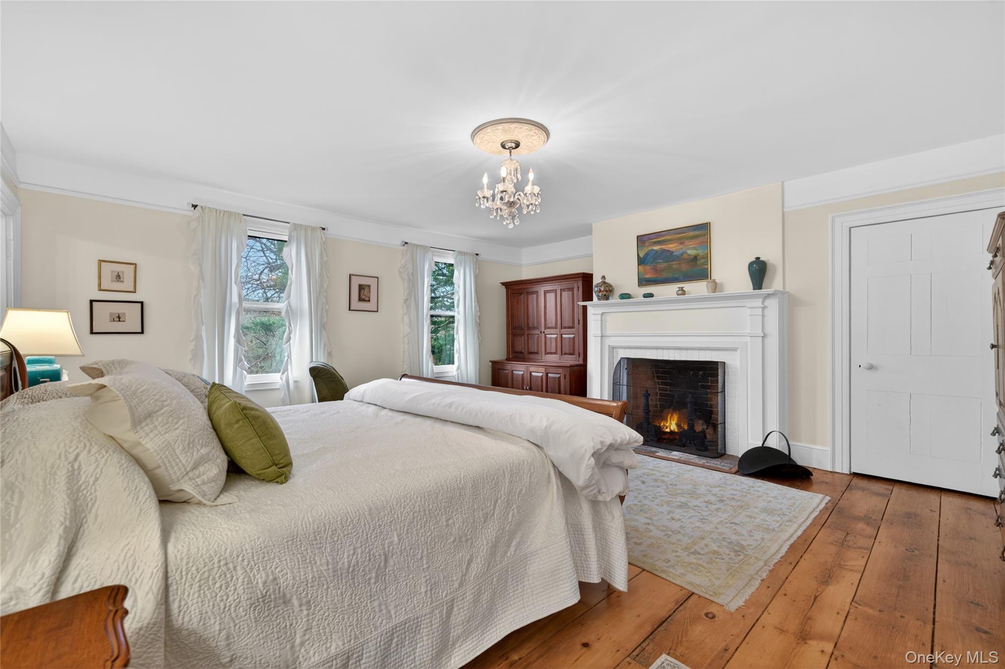 90 Quaker Avenue Cornwall, NY 12518 - Photo 27 of 50 a spacious bedroom with a bed and a fireplace