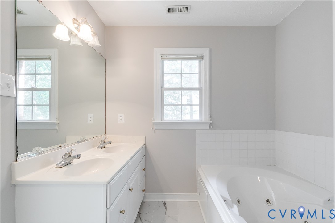 6701 Caboose Lane Sandston, VA 23150 - Photo 14 of 28 Spa-like primary bathroom with dual vanities, jett