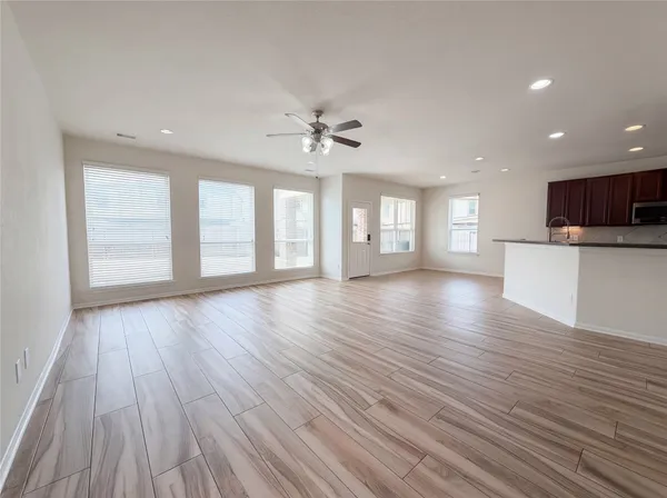 a view of an empty room with a kitchen