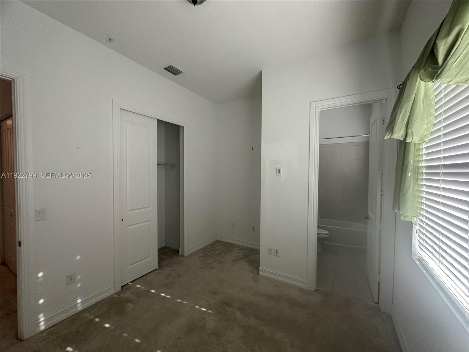 11718 Southwest 13th Ct. Pembroke Pines, FL 33025 - Photo 12 of 35 an empty room with windows