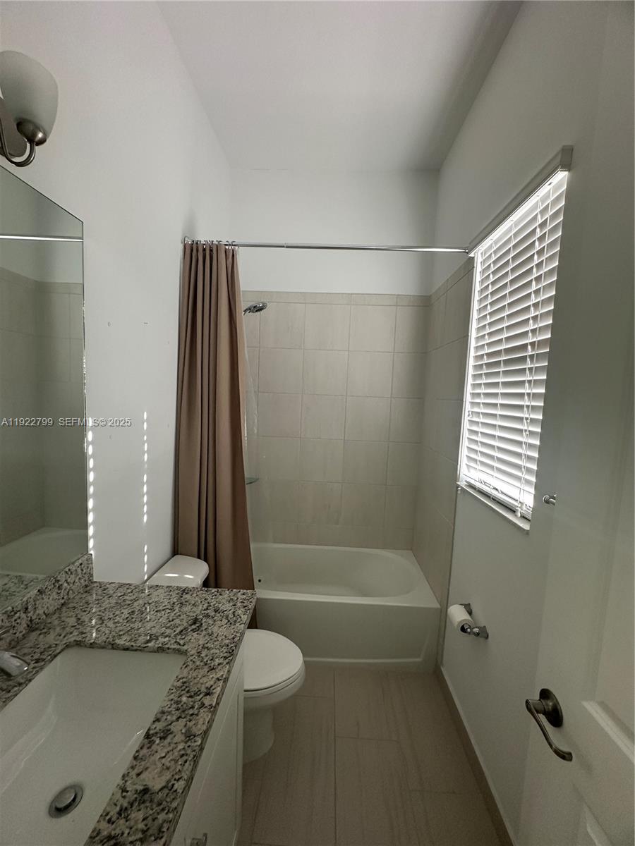 11718 Southwest 13th Ct. Pembroke Pines, FL 33025 - Photo 13 of 35 a bathroom with a granite countertop sink and a mirror