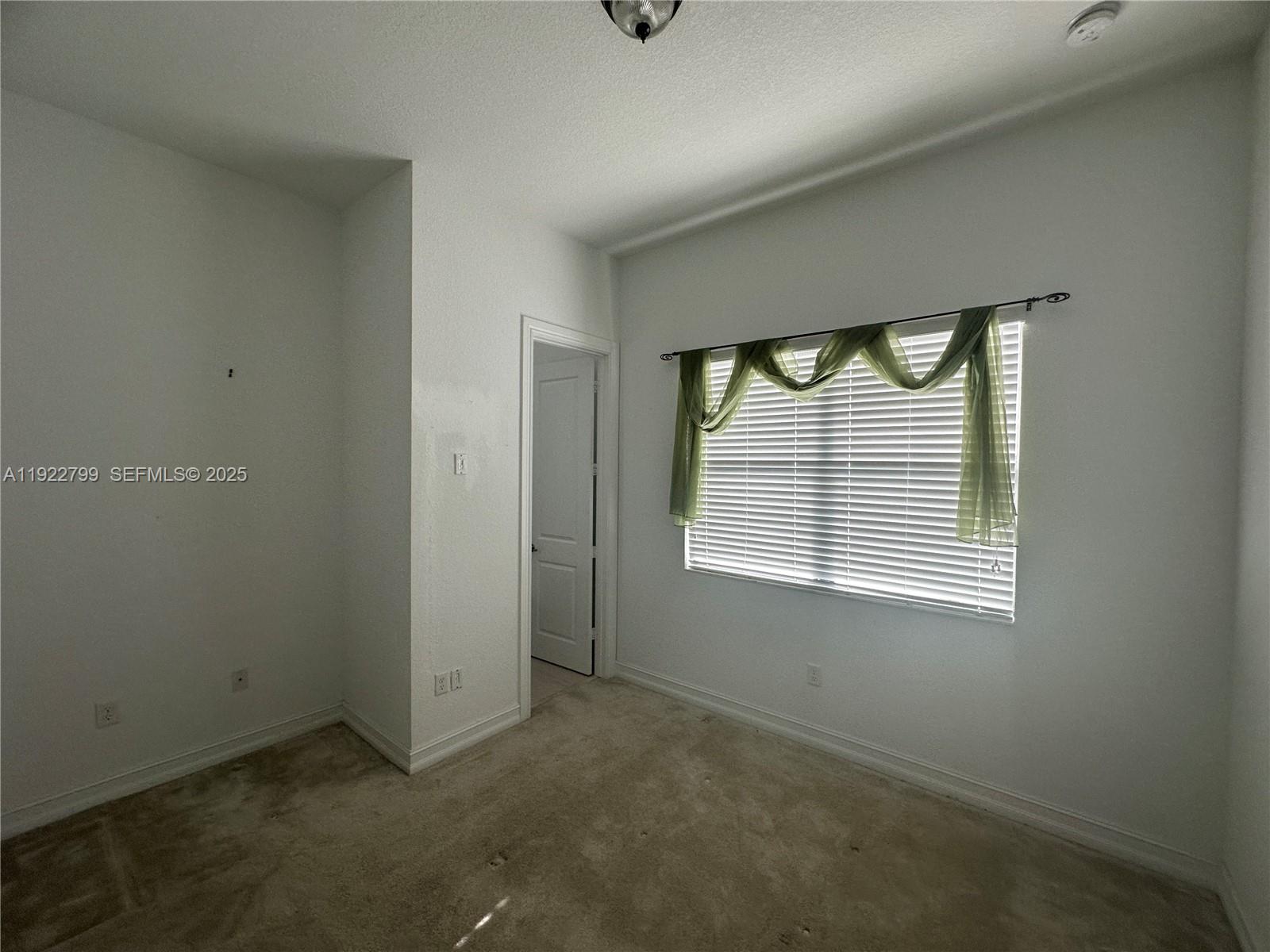 11718 Southwest 13th Ct. Pembroke Pines, FL 33025 - Photo 14 of 35 an empty room with windows