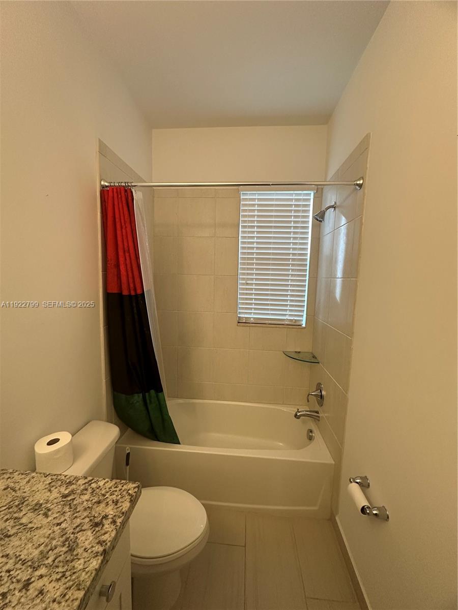 11718 Southwest 13th Ct. Pembroke Pines, FL 33025 - Photo 17 of 35 a bathroom with a toilet and a shower