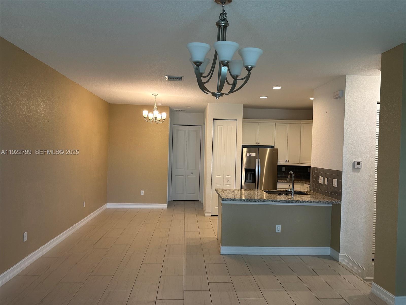 11718 Southwest 13th Ct. Pembroke Pines, FL 33025 - Photo 25 of 35 a view of a kitchen with a sink and refrigerator