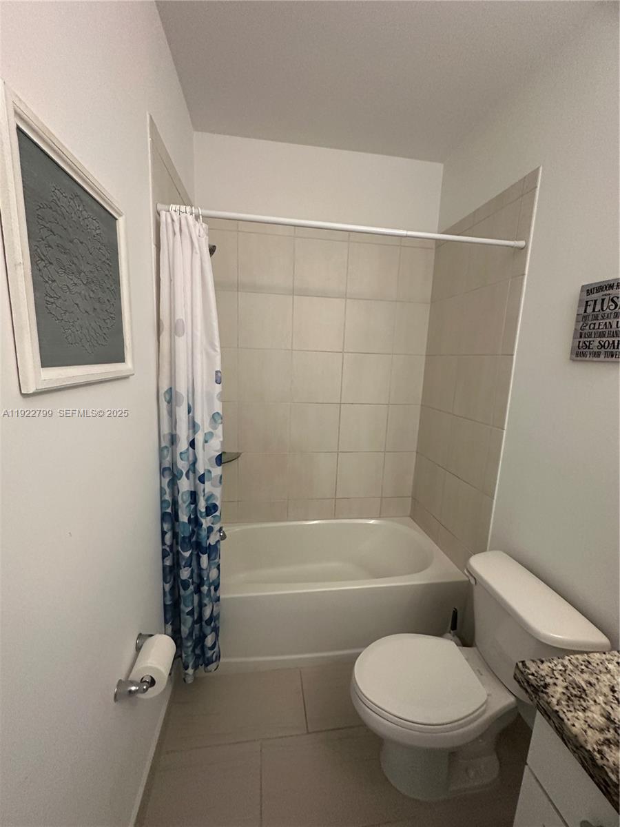 11718 Southwest 13th Ct. Pembroke Pines, FL 33025 - Photo 30 of 35 a bathroom with a toilet and a shower