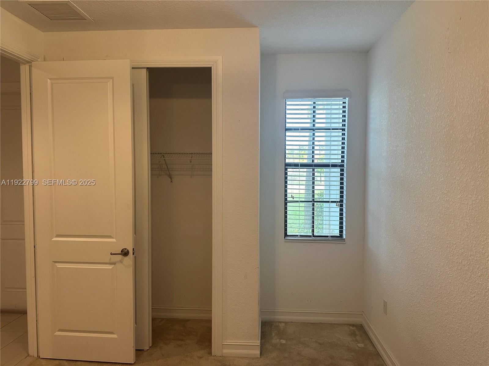 11718 Southwest 13th Ct. Pembroke Pines, FL 33025 - Photo 31 of 35 an empty room that has a window in it