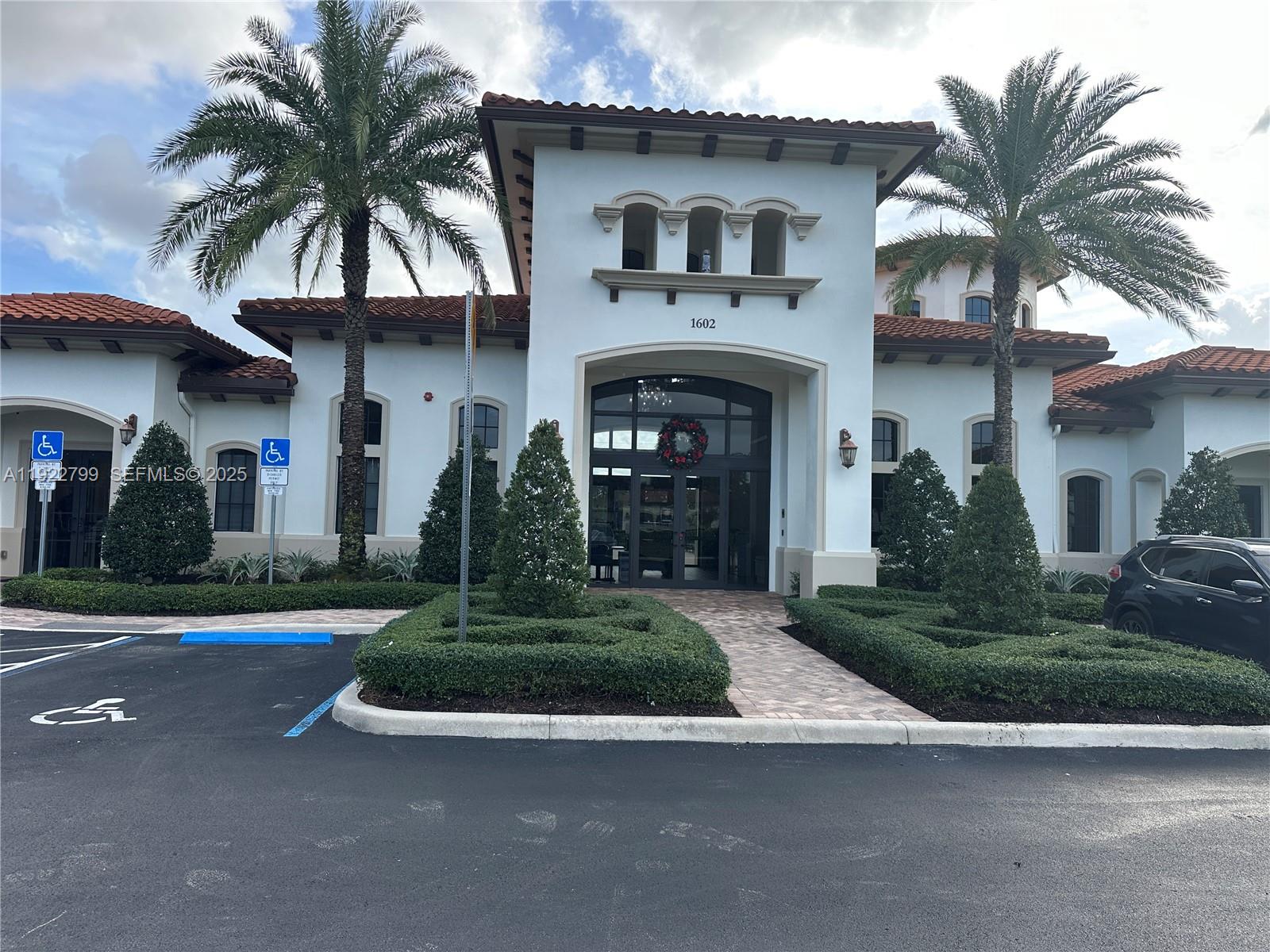 11718 Southwest 13th Ct. Pembroke Pines, FL 33025 - Photo 34 of 35 a front view of a house with a garden and trees