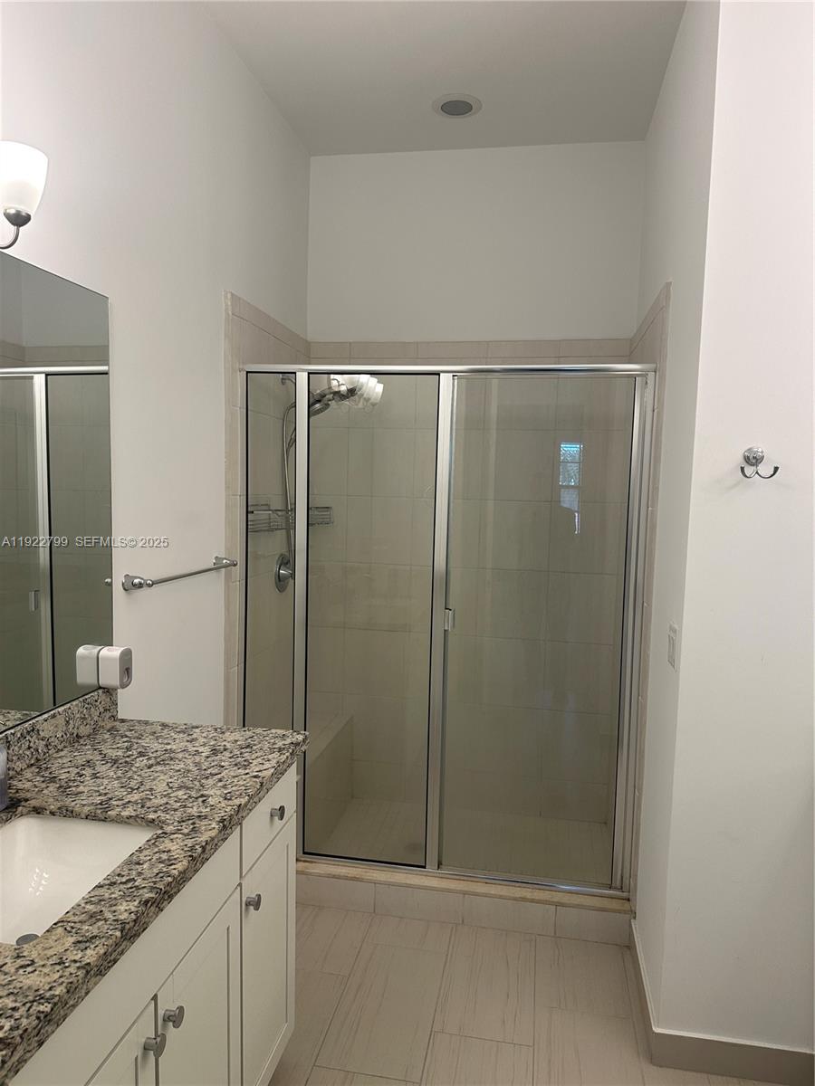 11718 Southwest 13th Ct. Pembroke Pines, FL 33025 - Photo 7 of 35 a bathroom with a granite countertop shower and a sink