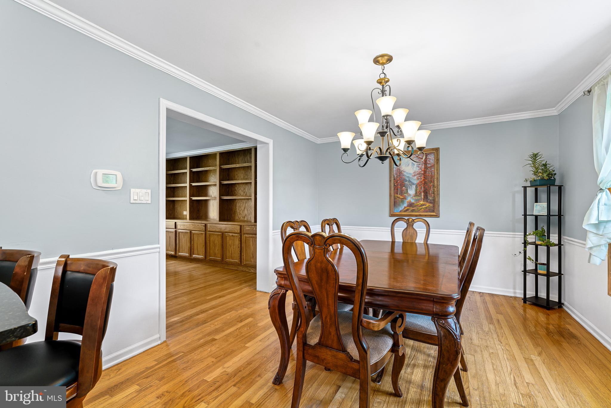 7 Congress Drive Bear, DE 19701 - Photo 6 of 37 a dining room with furniture wooden floor a chandelier and a rug