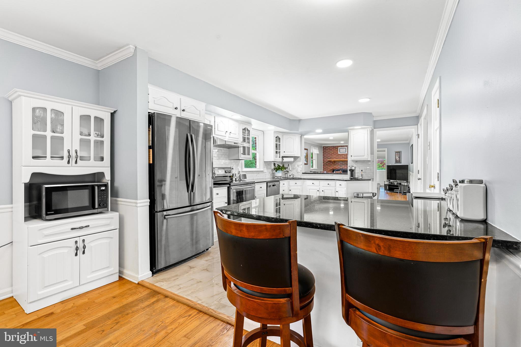 7 Congress Drive Bear, DE 19701 - Photo 7 of 37 a kitchen with stainless steel appliances granite countertop a sink stove and refrigerator