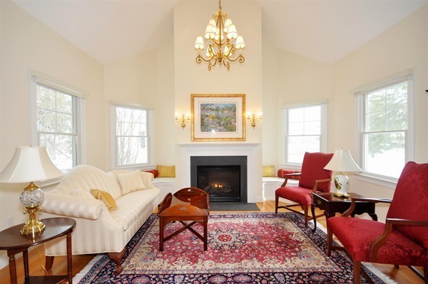 9 Oldham Road Arlington, MA 02474 - Photo 5 of 29 a living room with furniture a chandelier and a fireplace